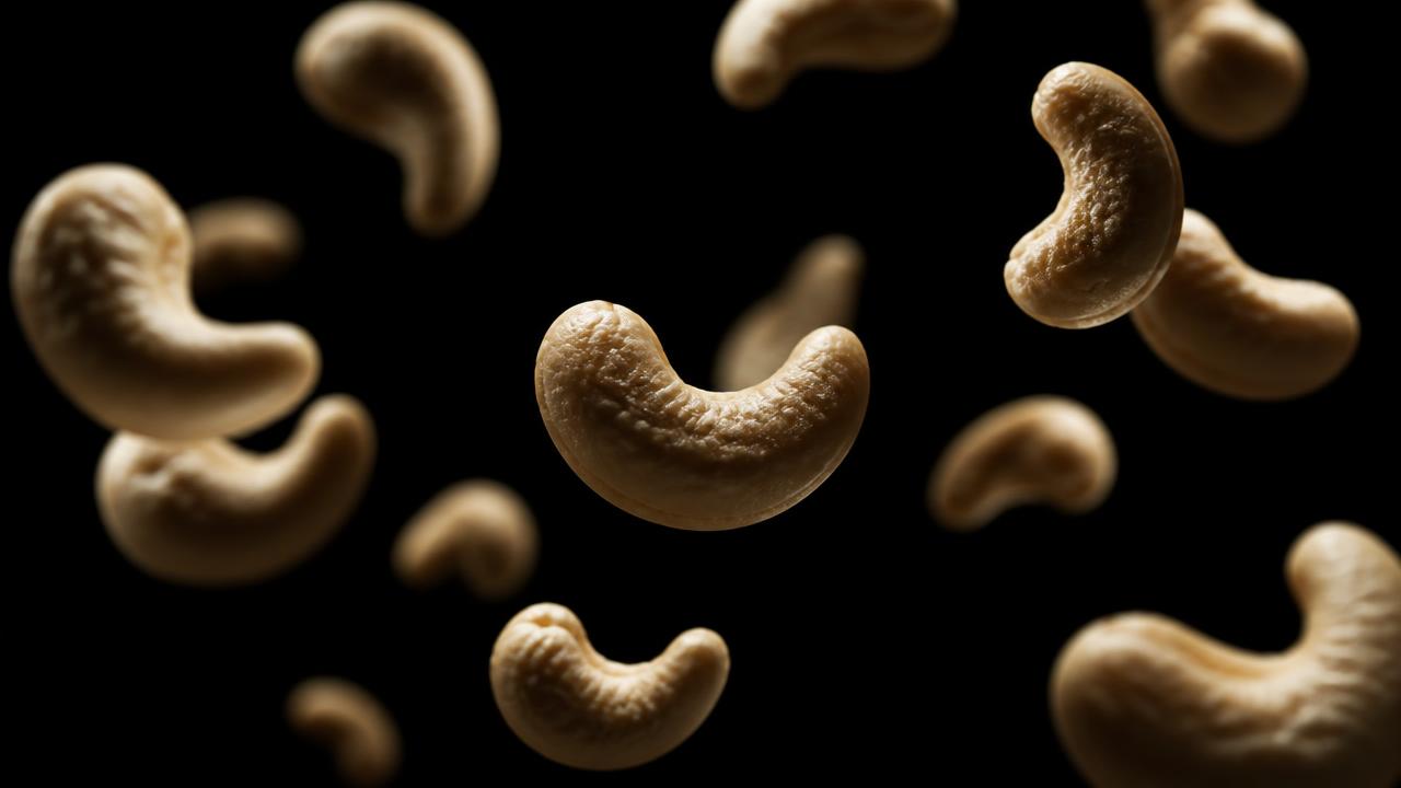 Cashews photographed against a dark studio background